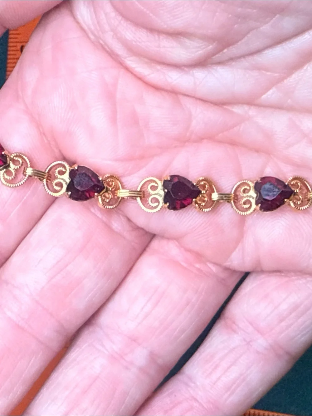 Source Unknown Gold Tone Bracelet with Deep Red Heart Stones
